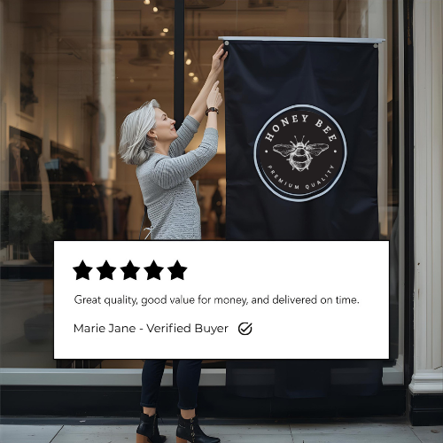 Person hanging a Honey Bee branded banner with a five-star review displayed below.